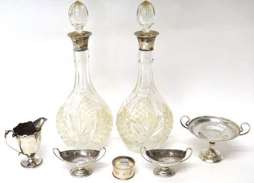 Silver and silver mounted wares, comprising; a twin handled sweetmeat's stand, on a circular foot, a cream jug, Birmingham 1922, a pair of Victorian t