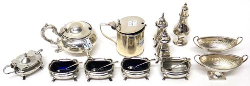 Silver, comprising; a set of four salts, each raised on four feet, Sheffield 1917, a pair of twin handled boat shaped salts, with partly fluted decora