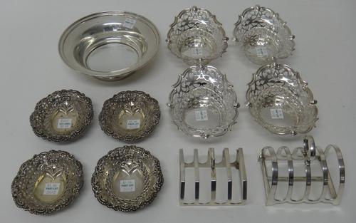 Silver, comprising; a circular bowl, having a loaded foot, a five bar toastrack of angular form, Birmingham 1930 and four small bonbon dishes, having