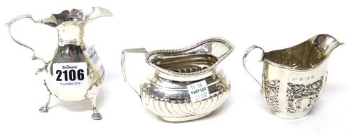 Silver, comprising; a cream jug of baluster form with a scrolling handle and raised on three feet, in the 18th century taste, Chester 1922 and two fur