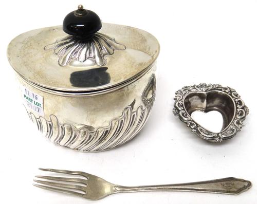 Silver, comprising; a Victorian oval tea caddy with partly spiral fluted decoration and with a black finial to the lid, London 1896, a heart shaped sa