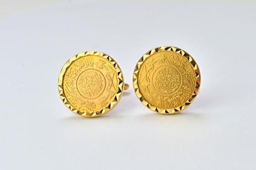 A pair of gold cufflinks, detailed 750, the fronts mounted with Middle Eastern gold coins, the backs with folding bar fittings, gross weight 29 gms. I