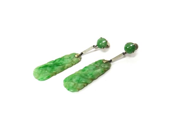 A pair of white gold and jade pendant earrings, each with a carved drop decorated with fruit motifs and with a circular surmount, the screw fittings d