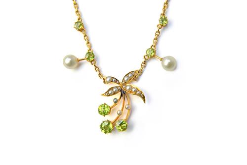 A gold, peridot, seed pearl and cultured pearl necklace, the front with a foliate spray motif, on a gold oval link chain, with a cylindrical clasp, de