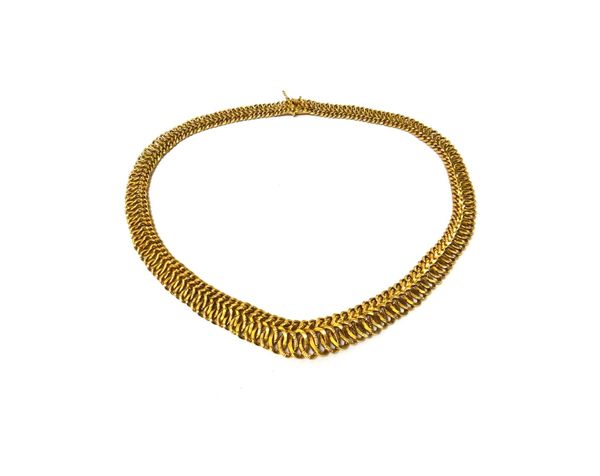 A European gold necklace, in a graduated multiple link design, on a snap clasp, with a safety catch, weight 29 gms.