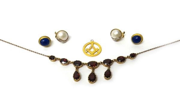 A 9ct gold and garnet set necklace, mounted with a row of seven graduated oval cut garnets and with three pear shaped garnet drops to the front, a pai