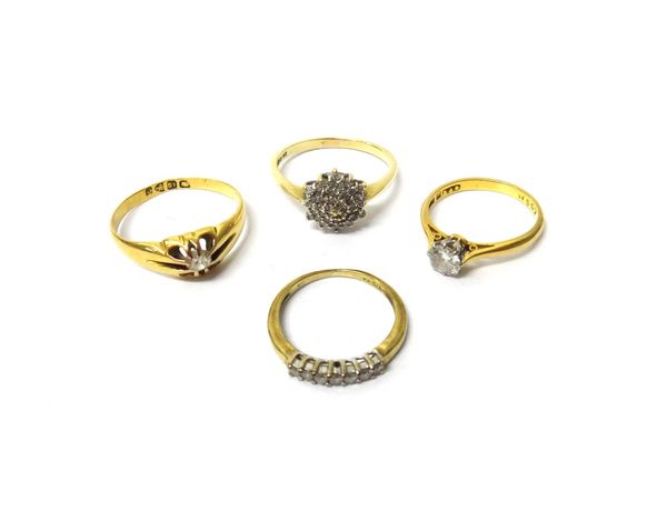 A gold and platinum, diamond set single stone ring, claw set with a circular cut diamond, an 18ct gold and diamond set single stone ring, claw set wit