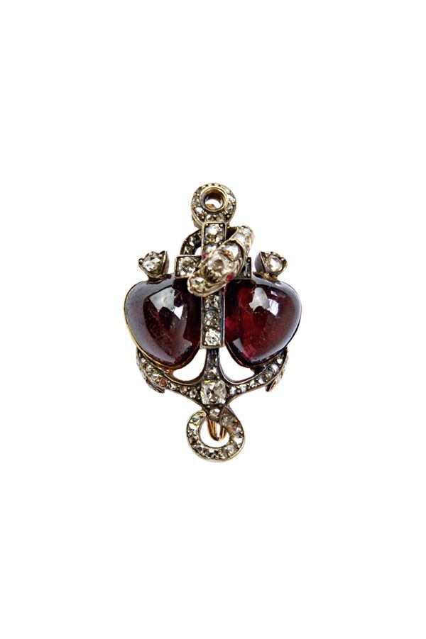 A Victorian diamond and carbuncle garnet set brooch, with Faith, Hope, Charity and serpentine motifs, mounted with two carbuncle garnets and otherwise