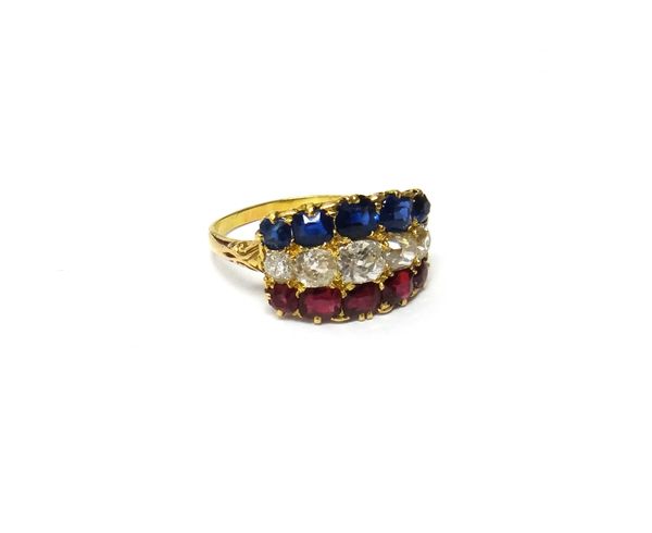 A gold, diamond, ruby and sapphire ring, mounted with a row of five graduated cushion shaped diamonds to the centre, a row of five graduated cushion s