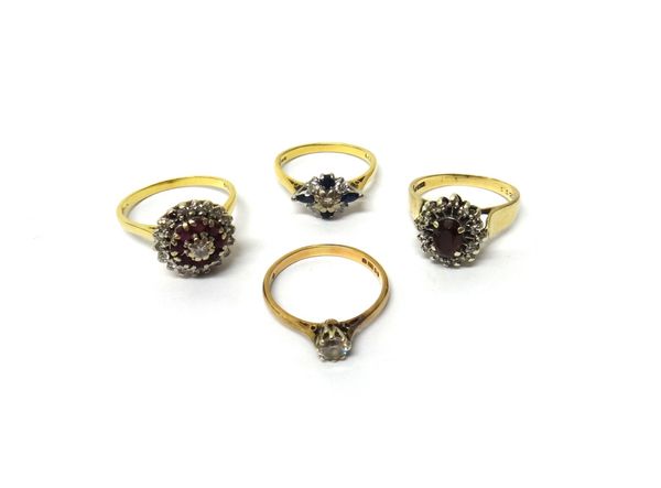 An 18ct gold, diamond and ruby set cluster ring, claw set with the principal circular cut diamond at the centre, in a surround of circular cut rubies