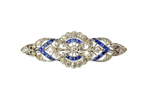 A diamond and sapphire brooch, in a pierced openwork tapering design, mounted with circular cut diamonds and with rows of calibre cut sapphires, in th