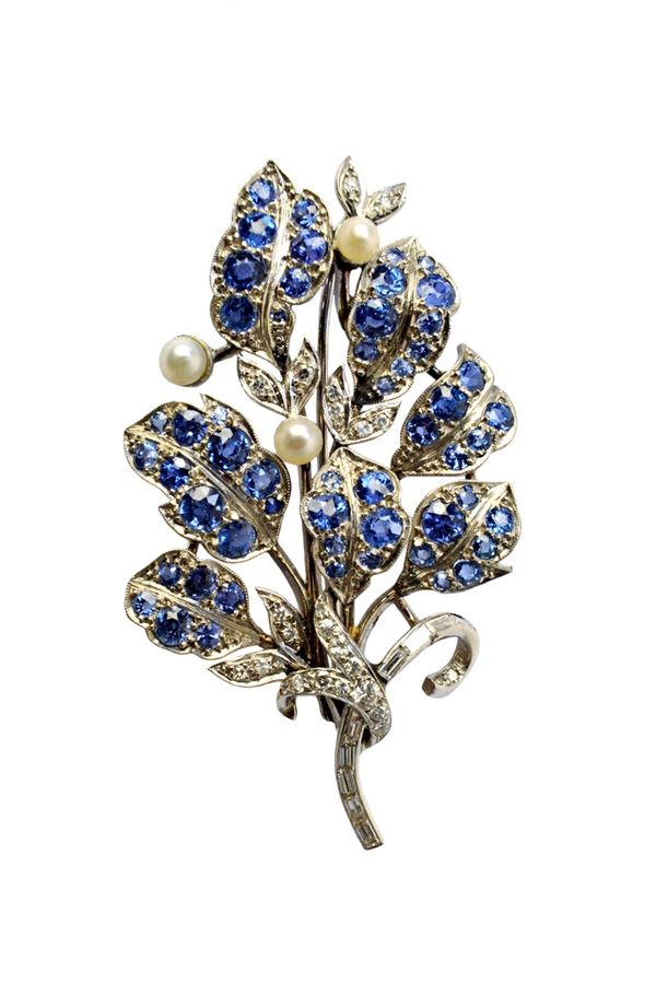 A sapphire, diamond and cultured pearl brooch, designed as a foliate spray, the stem mounted with a row of baguette diamonds and otherwise mounted wit