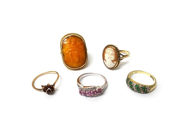 A gold mounted panel shaped amber ring, with a winged insect motif, detailed 9 CT, a 9ct gold mounted oval shell cameo ring, carved as the portrait of