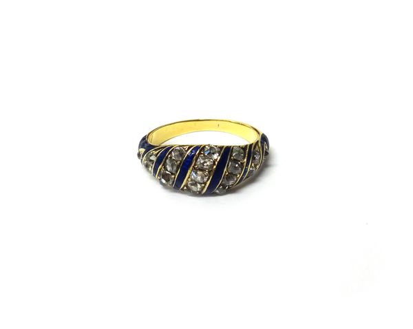 A Victorian gold, diamond set and blue enamelled ring, mounted with serpentine rows of cushion shaped diamonds and with blue enamelled serpentine divi