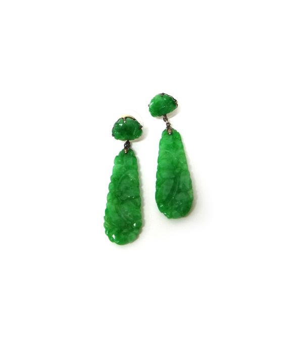 A pair of carved jade pendant earrings, each in a drop shaped design, decorated with flowers and with a carved jade surmount, the tops with post fitti