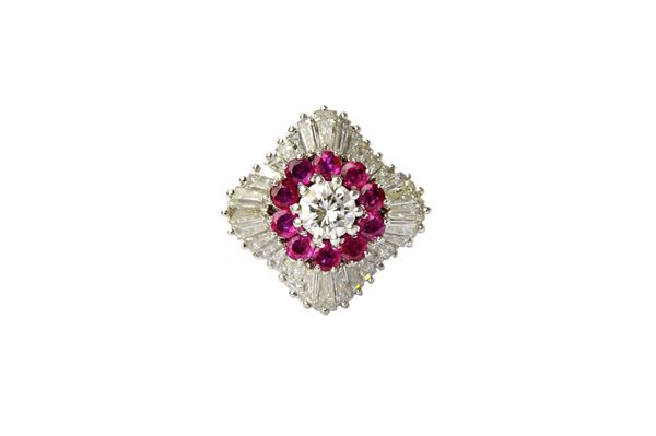 A platinum, diamond and ruby set cocktail ring, claw set with the principal circular cut diamond at the centre, within a surround of circular cut rubi