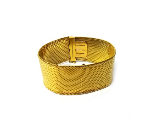 A French gold bracelet, in a wide woven link design, on a snap clasp, fitted with a safety chain, width 2.5cm, weight 44 gms.