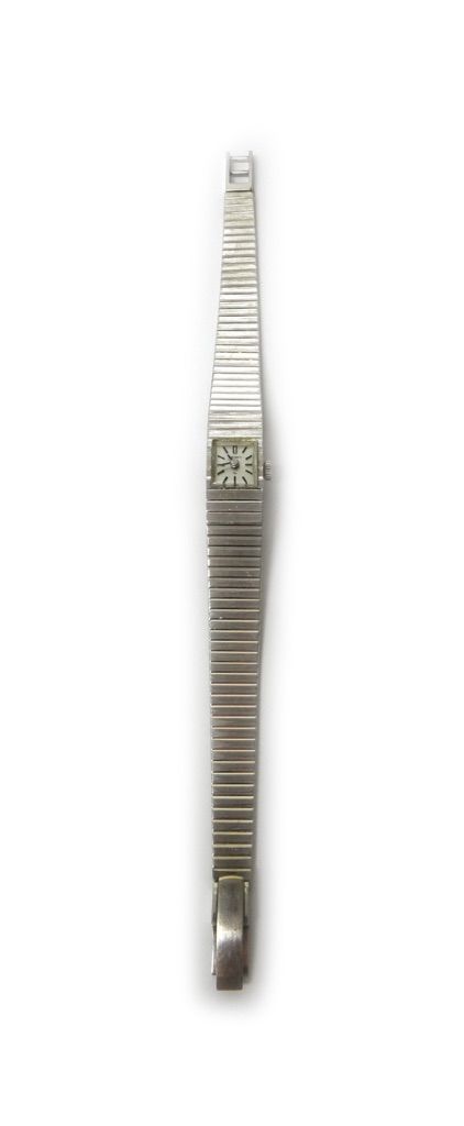 A lady's Seiko white gold bracelet wristwatch, the signed square dial with black baton shaped numerals, on a tapering bar link bracelet, with a foldov