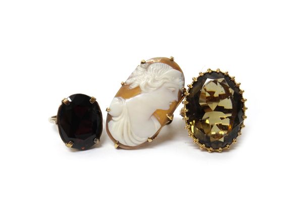 A gold mounted oval shell cameo ring, carved as the portrait of a lady, a 9ct gold ring, claw set with an oval cut smoky quartz and a 9ct gold ring, c