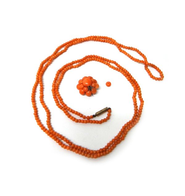 A single row necklace of coral beads, on a snap clasp, length 130cm and a coral brooch (one coral bead detached, but present), (2).