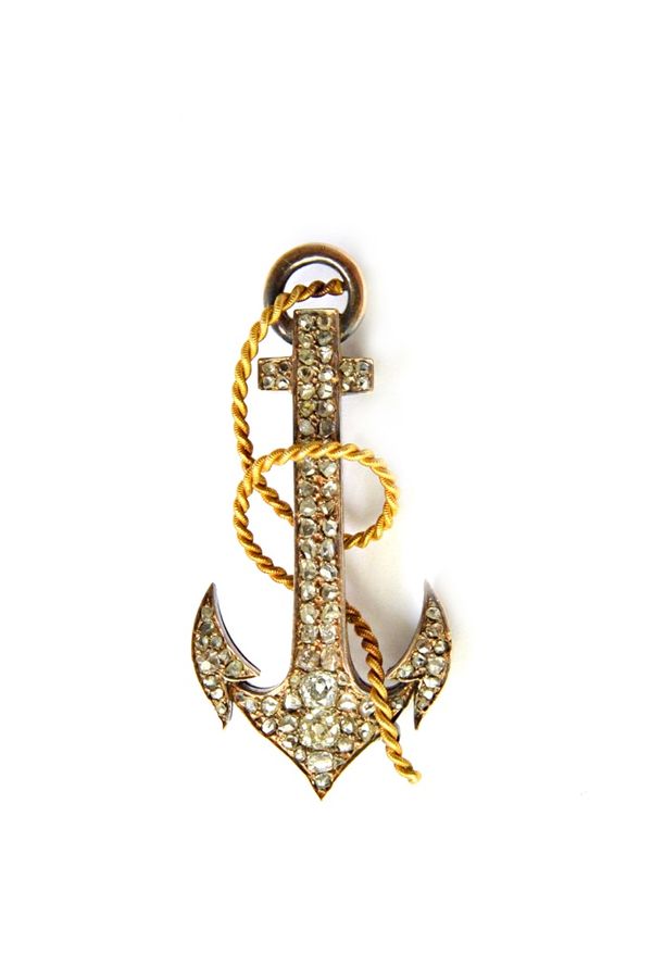 A Russian gold and silver, diamond set brooch, designed as an anchor with a rope, detailed 56, bears Faberge mark. Illustrated.