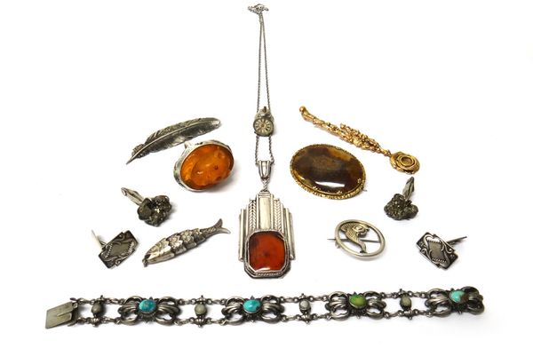 A group of jewellery, comprising; two pairs of cufflinks, an oval agate set brooch, two further brooches, a carved amber ring, with a lion's face moti