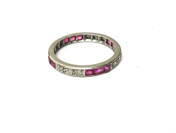 A diamond and ruby full eternity ring, mounted with rows of three circular cut diamonds alternating with rows of three calibre cut rubies, ring size M