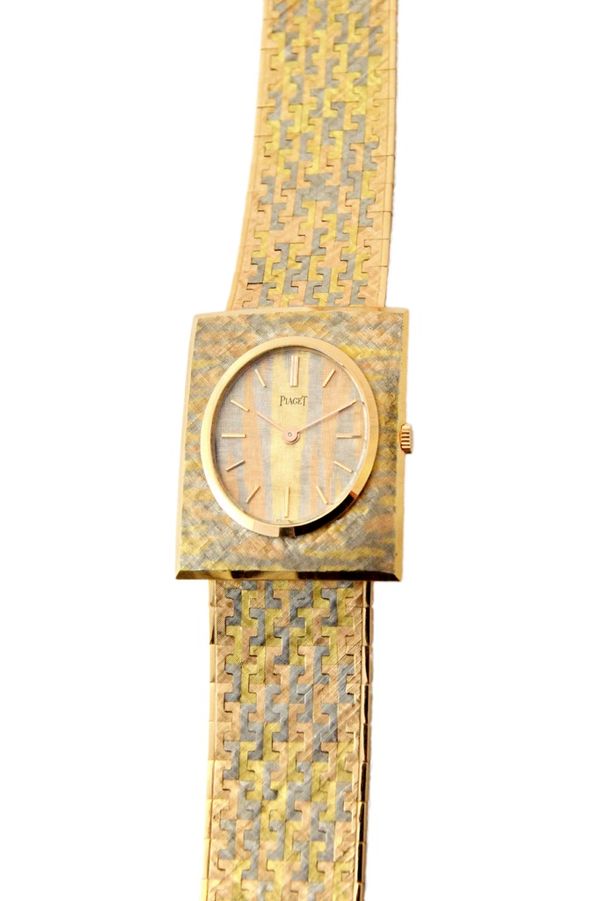 A three colour gold Piaget bracelet wristwatch, the signed oval dial with gilt baton shaped numerals, detailed to the case back 916 A3 81895, with a f