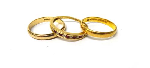 A gold, ruby and diamond set half hoop ring, mounted with alternating circular cut rubies and diamonds, a 22ct gold plain wedding ring, weight 3.3 gms
