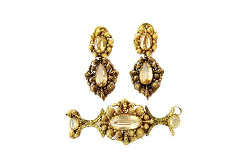 A gold and topaz brooch and a pair of gold and topaz earclips, each in a cannetille work design, mounted with oval cut and pear shaped topaz, the earr