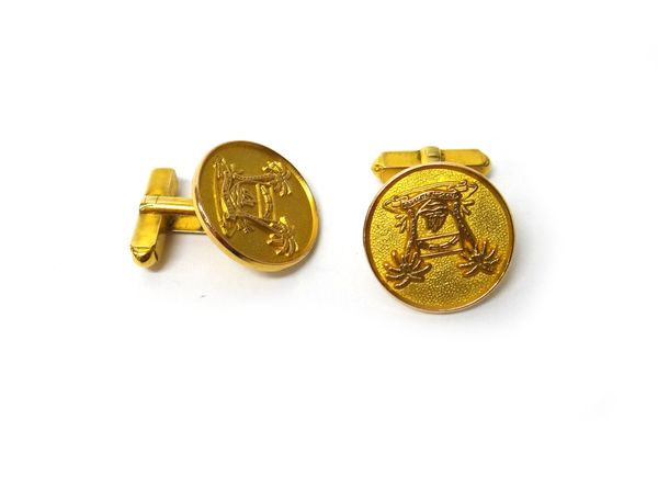 A pair of 9ct gold cufflinks, the circular fronts with Middle Eastern crest motifs, with palm trees, the backs weight folding bar fittings, Birmingham