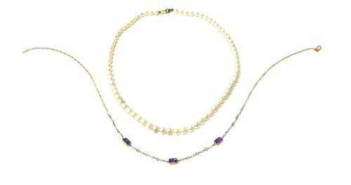 A 9ct gold, amethyst and seed pearl necklace, the front mounted with three rectangular cut amethysts and with rows of pairs of seed pearls spaced at i