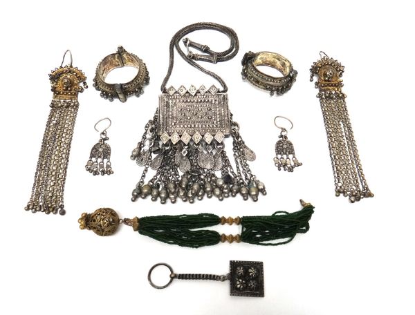 A collection of Islamic jewellery, comprising; a large rectangular pendant, fitted with rows of drops and with a wirework link neckchain, two bangles,