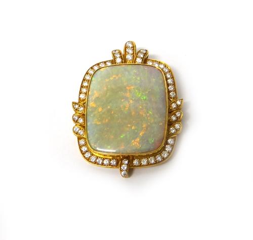 A gold, opal and diamond set pendant, in a shaped rectangular panel shaped design, the central opal mounted within a surround of circular cut diamonds