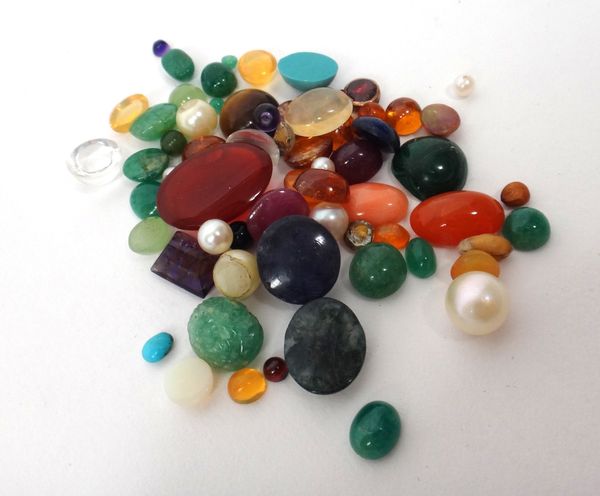 A collection of unmounted gemstones, comprising; facet cut, cabochon and carved gemstones, to include; topaz, amethyst, citrines, opals, fire opals, c