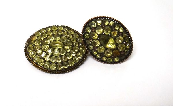 A gold mounted and silver set foil backed chrysolite set oval panel shaped ring, ring size L and a half and a foil backed chrysolite set oval brooch,