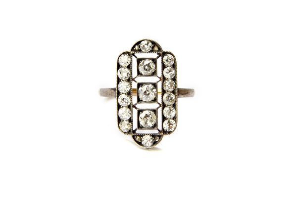 A Russian gold and silver set diamond panel shaped cluster ring, mounted with cushion shaped and rose cut diamonds and with the three principal diamon