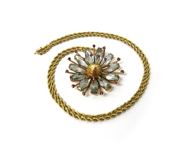 A gold, aquamarine and ruby pendant, designed as a flowerhead, mounted with two rows of small circular cut rubies enclosing the faceted aquamarines, o