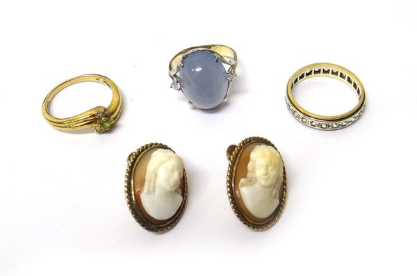 A 9ct gold, diamond and green gem set ring, in a crossover design, a diamond and cabochon blue stained agate set three stone ring, a gold and colourle