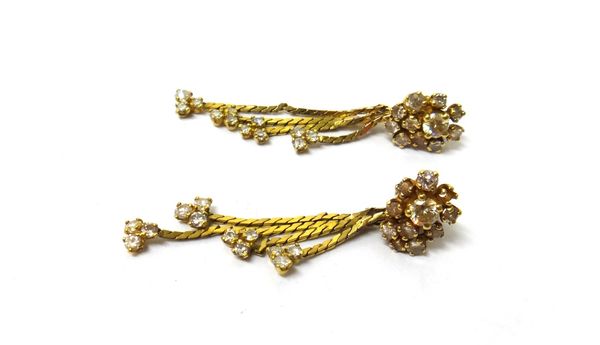 A pair of gold and diamond set pendant earrings, each top mounted with circular cut diamonds and with the principal diamond mounted to the centre of e