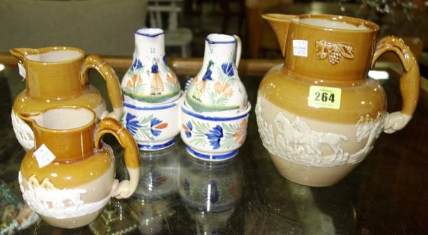 A group of three Doulton type stoneware jugs, two Quimper jugs and a twin division bottle holder (6). CAB