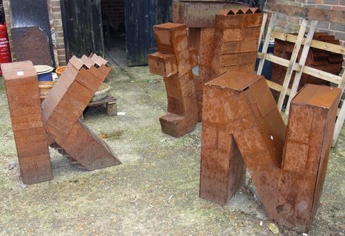 A group of six large iron metal letters. (6) OUT