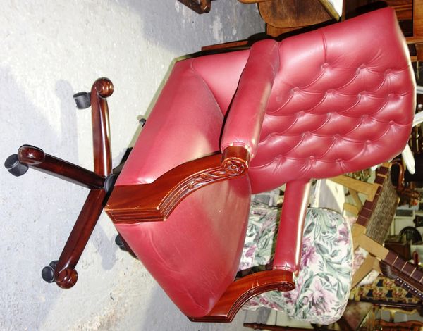 A 20th century mahogany and red leather button back swivel office chair.  I2