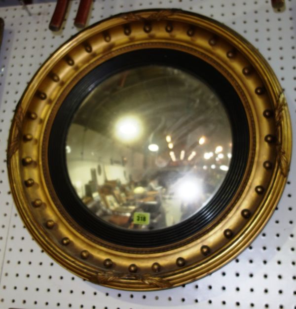 A Regency gilt framed circular convex wall mirror, 58cm.   MIR