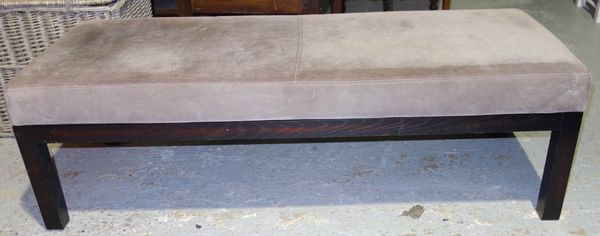 A 20th century suede upholstered rectangular footstool, on ebonised block supports, 131cm wide.  G7