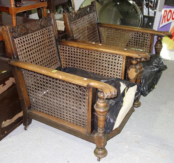 A pair of 20th century carved oak bergère armchairs. (2)  B3