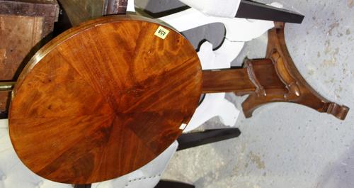 An early 19th century mahogany occasional table, the circular snap top on triangular column and three scroll feet, 50cm wide. E4