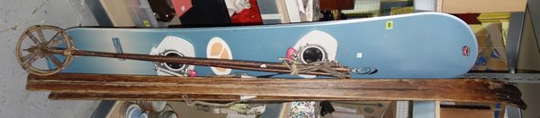 A pair of vintage skis and poles, a Solomon snow board, a Handy push lawn mower and a coat hook rail. GAL