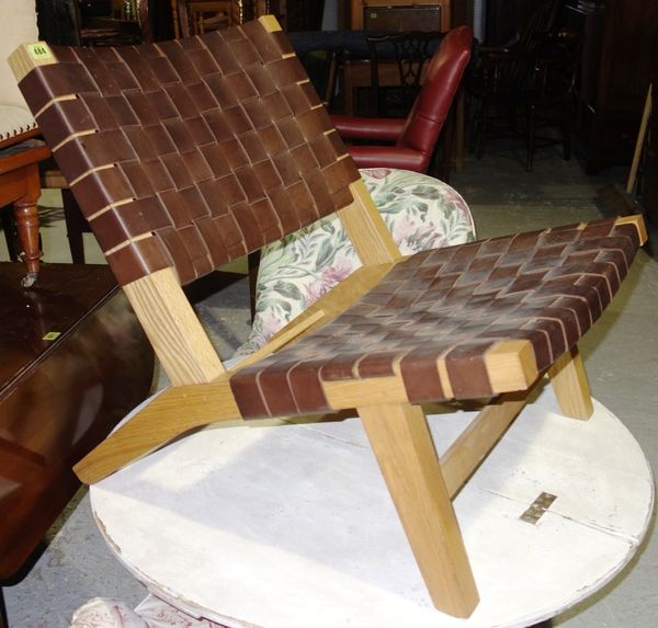 A 20th century oak framed leather upholstered chair.   H3