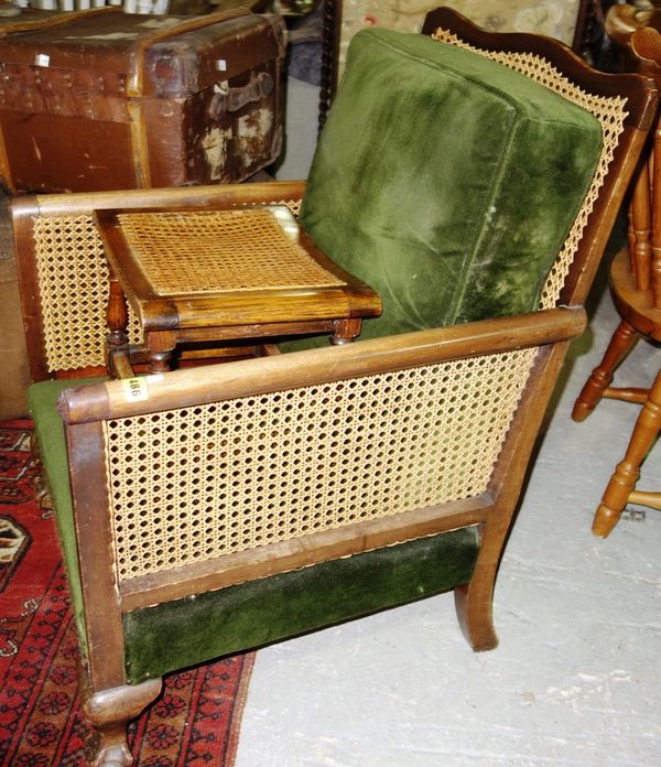 An early 20th century bergère chair together with a cane top stool. (2)  GAL